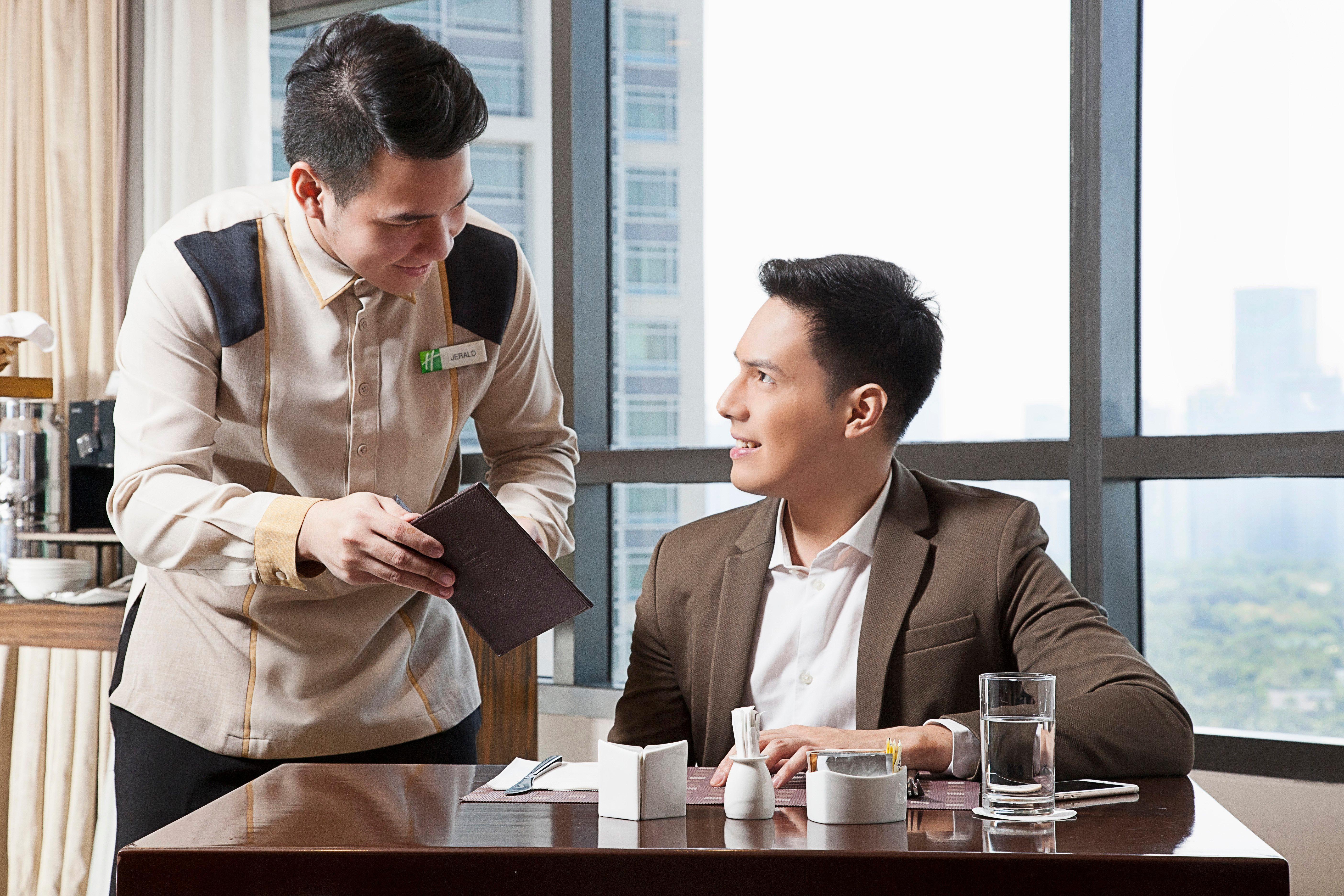 Holiday Inn & Suites Makati By Ihg Makati City Exterior foto A butler serving a guest